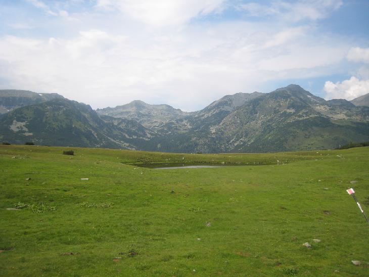 Sedlo Saua Plaiul Mic 1 879 m.n.m. s výhledem na Vf. Peleaga (vpravo) a Vf. Retezat (uprostřed). Poté následoval sestup asi 300 m dolů do chaty Buta.